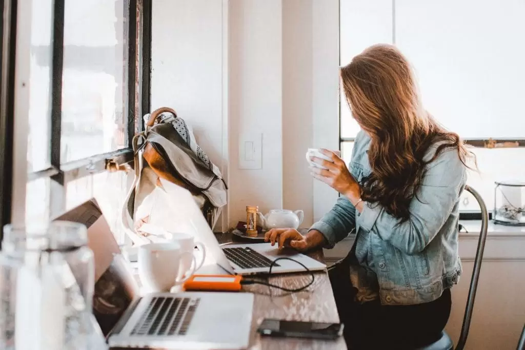 Person working, drinking coffee | Cafe near Stay Kooook Hotel in Bern Wankdorf.