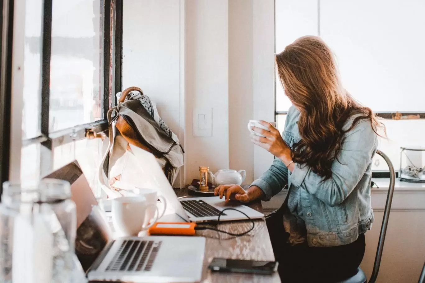 Person working, drinking coffee | Cafe near Stay Kooook Hotel in Bern Wankdorf.