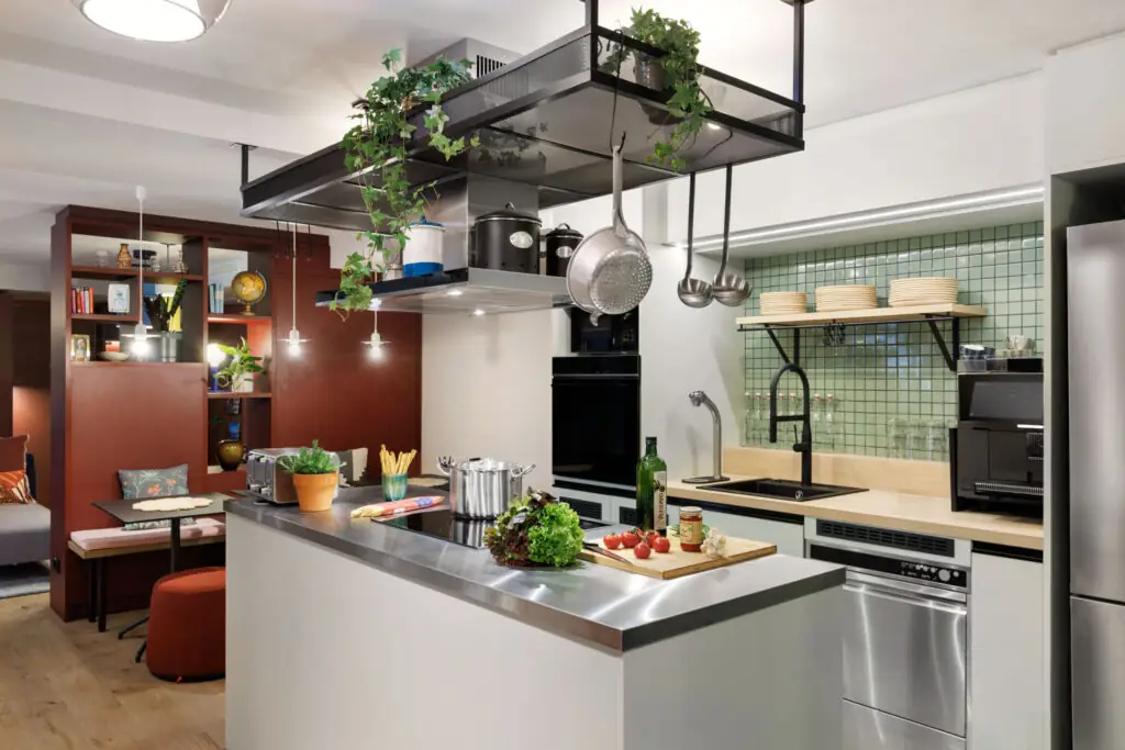 Fully equipped community kitchen with stove, oven, coffee machine, dishes and cooking utensils