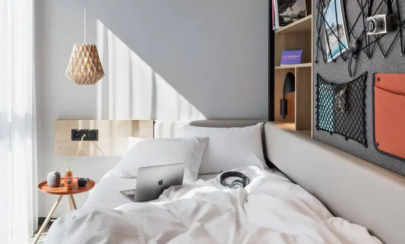 A bright, cosy Stay KooooK Studio with a bed, a workspace and smart storage solutions for relaxed living and working.