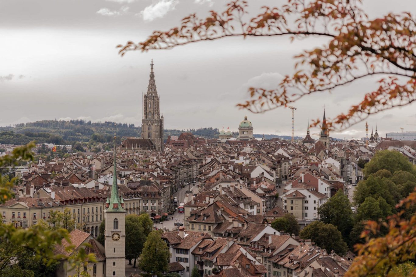 View over Bern’s old town with dense rooftops and the prominent spire of the cathedral.